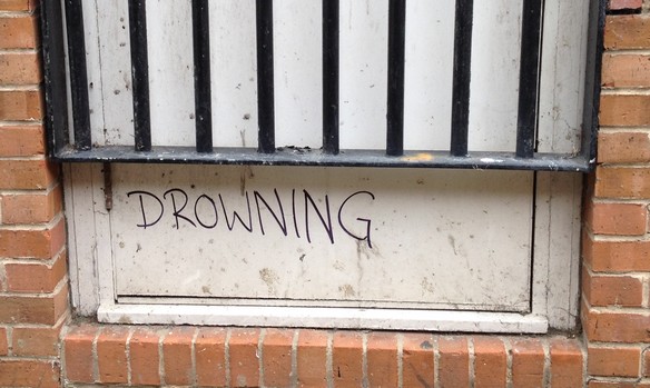 Graffiti scrawled on wall reads: Drowning